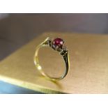 18ct Yellow Gold ruby and diamond ring. Set with single large ruby to centre and two diamonds