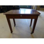 Mahogany low sewing box of one drawer with mother of pearl escutcheon. on legs with metal castors