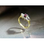 18ct Gold Ruby and Diamond cluster ring in a diamond shaped setting. Central high set ruby is
