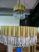 Large retro solid brass chandelier with extensive glass droplets and matching wall lights.