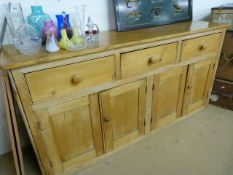 Antique pine dresser base of four cupboards and three drawers