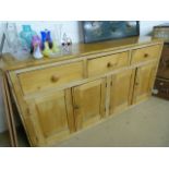 Antique pine dresser base of four cupboards and three drawers