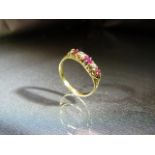 18ct Yellow Gold Ruby and Diamond Boat ring set with three bright clean rubies, interspersed by