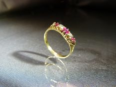 18ct Yellow Gold Ruby and Diamond Boat ring set with three bright clean rubies, interspersed by