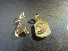 18ct Yellow Gold. - To include two pendants both hallmarked - 1 of a saxophone and one saying 'I