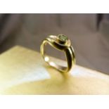 Modern cross-over style 9ct Dress Ring, set with an approx 4mm diameter Peridot. Size UK - N and USA