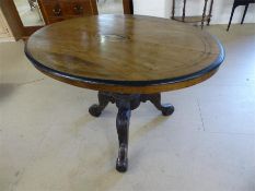 Edwardian inlaid mahogany oval table with carved tripod base
