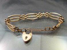 9ct Rose Gold gate bracelet with love heart padlock and safety chain. Needs repairing at the