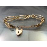 9ct Rose Gold gate bracelet with love heart padlock and safety chain. Needs repairing at the
