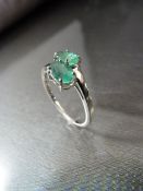 9ct White Gold emerald crossover ring set with two oval Emerald stones