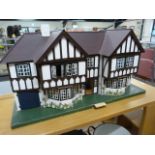 A Triang 'Stockbrokers' Tudor style dolls house, 1930s, grey painted triple apex roof, three