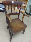 Single Elm seated carver chair with turned spindle back.