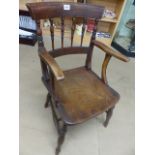 Single Elm seated carver chair with turned spindle back.