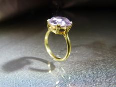 18ct Gold ring set with an oval Pale Amethyst stone in claw setting. Stamped 18ct to shank. Ring