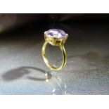 18ct Gold ring set with an oval Pale Amethyst stone in claw setting. Stamped 18ct to shank. Ring