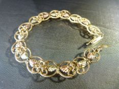 10K Gold 7" long 2 tone Gold Bracelet of filigree links. Approx 10mm Wide with Yellow and Rose