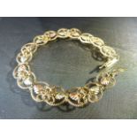 10K Gold 7" long 2 tone Gold Bracelet of filigree links. Approx 10mm Wide with Yellow and Rose