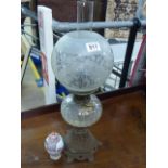 Victorian oil lamp with clear glass well and frosted glass shade with foliate scroll decoration