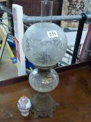 Victorian oil lamp with clear glass well and frosted glass shade with foliate scroll decoration