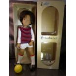 A Sasha Gregor doll, vinyl head and body, airbrushed detail to face, brown wig, dressed as a