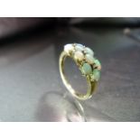 9ct Gold Opal and Diamond Ring. 10 oval opals interspersed with 7 small diamonds in an approx 7.