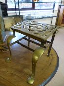 Unusual Brass Trivet with pad feet to front and raised with shelf underneath
