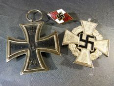 Two Nazi Iron crosses (one Hiltler youth) and a swastika badge.