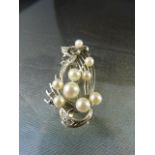 Silver vintage brooch set with 9 cultured pearls measuring from approx 6.8mm to 4.6mm and 4 white