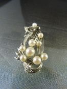 Silver vintage brooch set with 9 cultured pearls measuring from approx 6.8mm to 4.6mm and 4 white