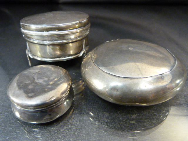 Three hallmarked silver items to include a pebble shaped snuff case and two silver pots. total