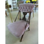 Low pink upholstered button back bedroom chair with turned wooden stretchers and pierced splat back