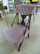 Low pink upholstered button back bedroom chair with turned wooden stretchers and pierced splat back