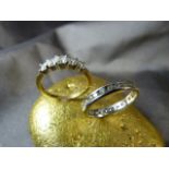 Two 18ct Gold CZ set rings. (1) White Gold full ET ring set with 29 brilliant cut CZ stones. (2)