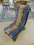 Victorian needle point nursing chair on scrolled legs and turned wooden stretchers