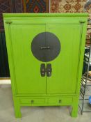 Oriental two door cupboard - painted green with bar lock to front.