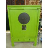 Oriental two door cupboard - painted green with bar lock to front.