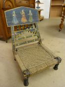 Indian chair with rope seat and handpainted decoration to back. The Seat is low and ebonised wood.