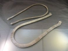 Hallmarked Silver necklace 1cm wide approx and approx 61cm long by J A Main Ltd along with Another