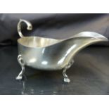 George V silver sauce boat hallmarked Sheffield 1925 with scroll handle and three hoof feet weight