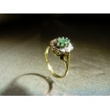 9ct Gold Emerald and Diamond Cluster Dress ring. The Oval approx 5.4mm x 3.9mm wide emerald is