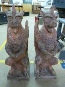 A pair of cast stone/Terracotta garden ornaments or pillar caps/finial's in the form of Gargoyles