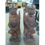 A pair of cast stone/Terracotta garden ornaments or pillar caps/finial's in the form of Gargoyles