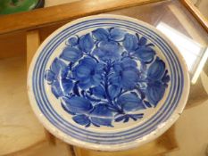 Blue and White Earthenware plate with hand pained floral decoration - slightly uneven in shape