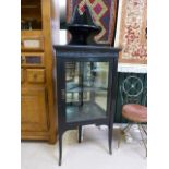 Black lacquered corner cabinet with mirrored back to shelves, over sits a singular corner shelf