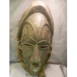 African carved mask with copper rope twist wire decoration inset to eyes, ears and forehead. Slitted