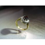 18ct Yellow Gold Garnet and Diamond cluster ring in a round setting. Marked 18ct to shank. Ring size
