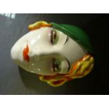 A Continental Art Deco style wall mask of a young woman. Impressed crown mark to back and F.X 965.