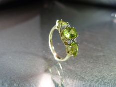 9ct Gold Peridot and Diamond Dress ring. Central oval stone approx 7.08mm x 5.08mm across with a 4.