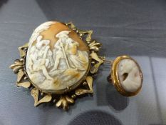 Gold unhallmarked Cameo brooch of regal form, The shell cameo having four persons playing various