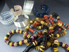Four wooden beaded necklaces along with four bangle bracelets etc